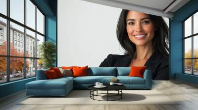 Confident young woman wearing a black blazer poses with arms crossed in a modern office setting Wall mural