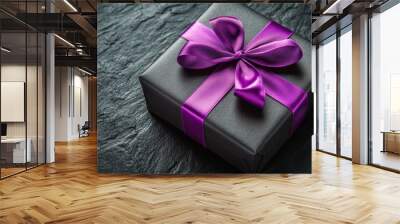 Elegant black gift box with a purple ribbon awaits opening on a dark background Wall mural