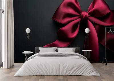 Elegant red satin bow on a dark background perfect for gift wrapping and decoration Wall mural