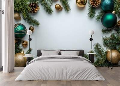 Festive green pine branches adorned with gold and teal ornaments ready for holiday decoration Wall mural