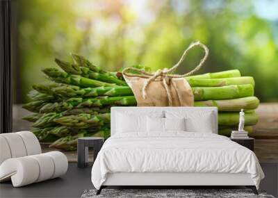 Fresh Green Asparagus Bundle on Wooden Table in Sunny Garden Wall mural