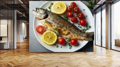 Grilled fish garnished with lemon and fresh vegetables on a white plate at a dining table Wall mural