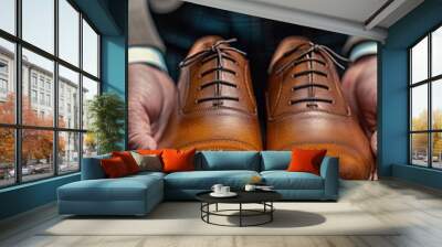 polishing leather shoes in hands of man Wall mural