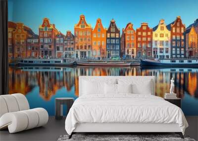 Scenic view of a canal with historic buildings and a boat in Amsterdam during sunset Wall mural