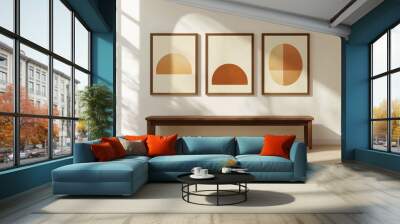 Stylish interior showcasing three modern art pieces in warm tones against a minimalist wall Wall mural