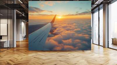 Sunrise view from an airplane window above the clouds during early morning flight Wall mural