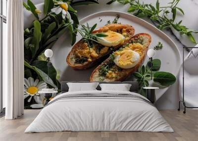 two bread sticks with eggs on a white plate with some herbs Wall mural