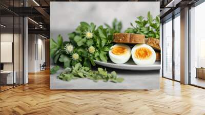 two bread sticks with eggs on a white plate with some herbs Wall mural