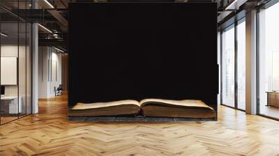 open book on a black background Wall mural