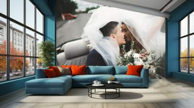 Happy bride and groom posing after wedding ceremony Wall mural