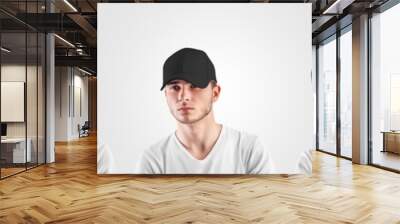 Mockup black baseball cap on a guy's head, front, side view, isolated on background, headwear for sun protection. Wall mural