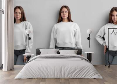 Mockup of a white crop sweatshirt on a beautiful girl in gray jeans, isolated on background, front, back view. Wall mural