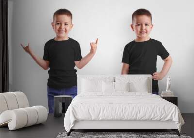 Mockup of black childrens t-shirt on smiling boy, casual kidswear isolated on background. Wall mural