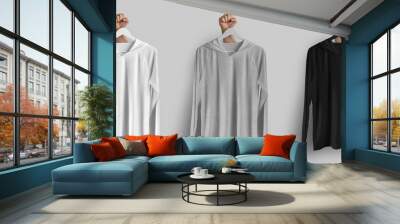 Mockup of white, black, heather longsleeve sun protection on hanger in hand, summer clothes for design, branding, front view. Wall mural