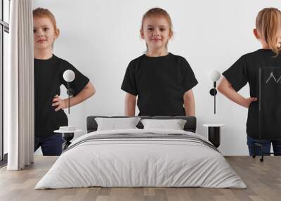 Set of black t-shirts on a cute baby, front and back view, isolated on background. Wall mural