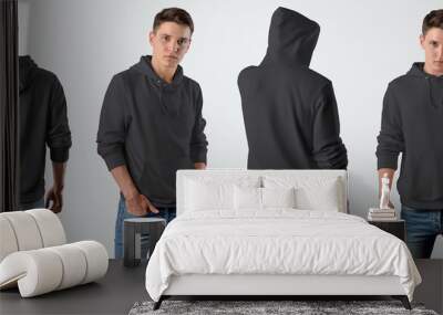 Template of a male blank black hoodie on a young guy for design presentation, set with a front and back pose. Wall mural