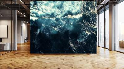 Captivating aerial view of deep blue ocean waves crashing, creating stunning foam patterns. Evokes adventure and danger, showcasing raw power of nature Wall mural