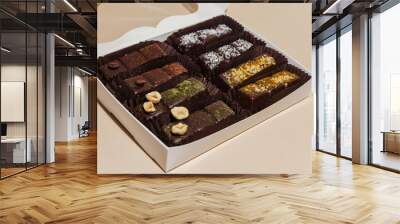 closeup various handmade vegan chocolate candies n the gift box on yellow background Wall mural