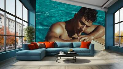 Strong face muscle male model in the open  summer shower on the vacation pool background with blue water on the nature beach on the sunset Wall mural