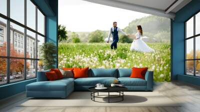 Wide angle shot of a bridal couple standing on a white flowering meadow Wall mural