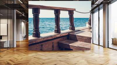 View from the old wooden ship on the sea horizon. Seagull on the ship. Vintage ship with ancient attributes, as in the days of pirates. Wall mural