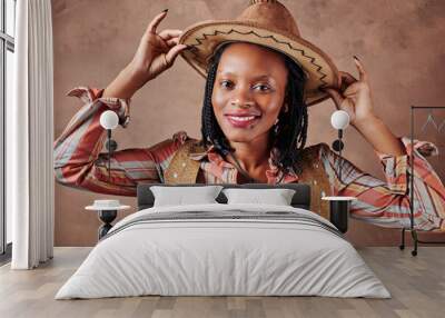 happy african american girl cowboy with hat. brown background. portrait Wall mural