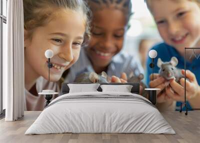 A group of enthusiastic school children looking at and holding grey baby mice in a school lab setting. It is a close-up photo on a bright sunny day.  Wall mural