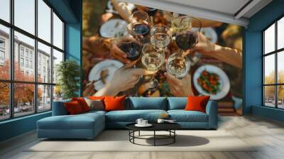 A group of friends toasting with glasses at an outdoor dining table  Wall mural