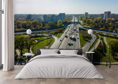 Aerial shot of  big freeway intersection in Warsaw, traffic going fast through many road flyovers. Poland. 30. October. 2019. Aerial view of a motorway with several traffic intersections. Wall mural