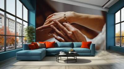 Beautiful elegant bride puts a bracelet on her hand, closeup. Girl put a bracelet on arm.Preparing the bride for the wedding ceremony. Wall mural