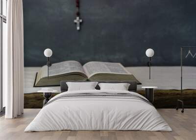 Bible and a crucifix on a old table. Beautiful dark background.Religion concept. Wall mural