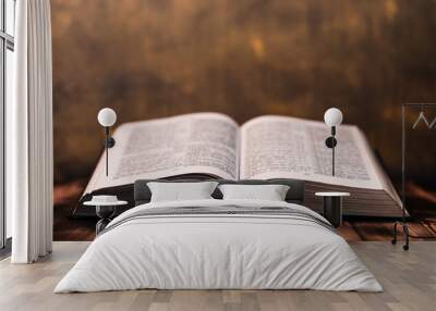 Bible and the crucifix on a wooden dark table. Beautiful gold background.Religion concept. Wall mural