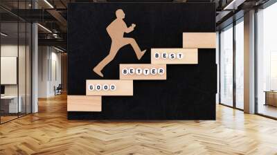 Good - Better - Best paper man climbing the steps to success in a conceptual image over black background Wall mural