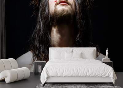 Jesus Christ of Nazareth with crown of thorns prays with raised head. Closeup portrait Wall mural