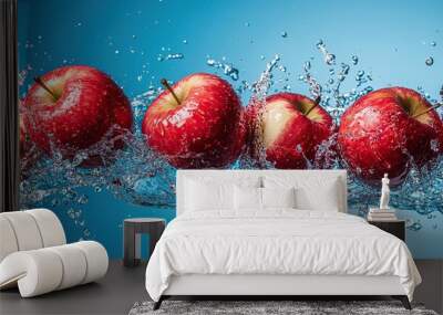 Flying red apples in water splash on cyan background, showcasing fruit levitating Wall mural