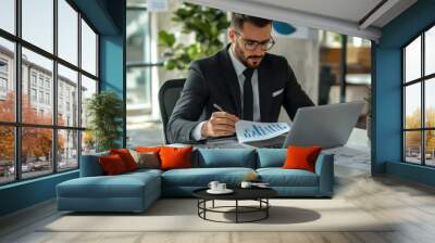 Marketer or analityc manager team dressed in suits working with paper charts and laptops at the white office interior Wall mural