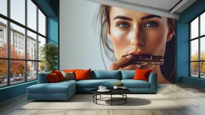 Sport athlete woman eats organic low-calorie black chocolate Wall mural