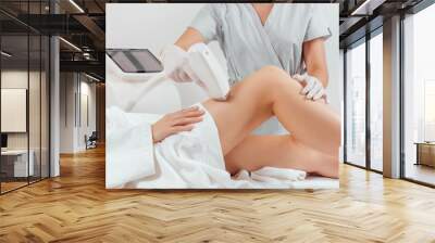 Young woman making body hair removal laser depilation in beauty center
 Wall mural