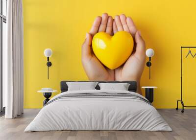 male hands holding a yellow heart, yellow background. ai generative Wall mural