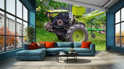 motor-block with green trailer. Development of traditional agricultural equipment and farming concept Wall mural