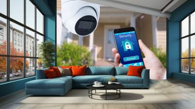 Security camera and smart home app, private house on the background. Wall mural