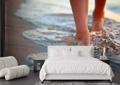 Female feet step on the sea wave Wall mural