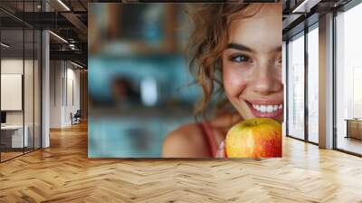 Smiling woman with bright teeth holding apple, healthy eating promotion, free text space Wall mural