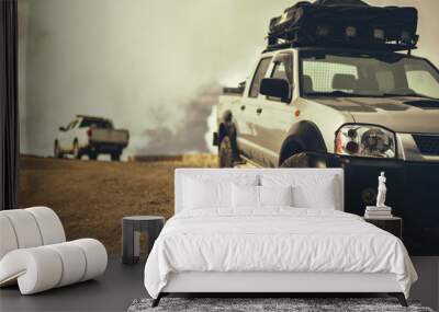 SUV pickup with trunk of roof on mountains road Wall mural