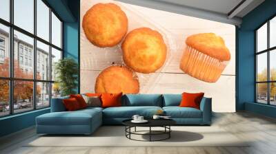 Sweet tasty muffins, close-up, on a painted wooden table Wall mural