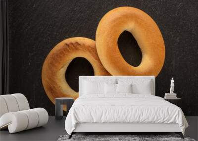 Two delicious bagels on slate stone, macro, top view. Wall mural