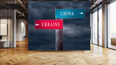 UKRAINE vs CHINA. Middle East conflict concept. Direction signs pointing to different sides. Wall mural