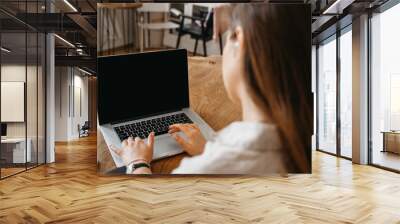 Woman Holding Laptop With Blank Screen. empty screen Wall mural