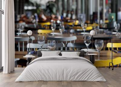 Casual restaurant interior with empty glasses and tables with yellow chairs Wall mural