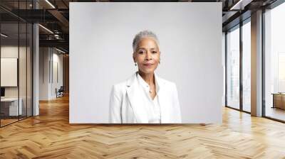 Portrait of a confident elder businesswoman in a suite on the solid white background. Copy space around. Wall mural